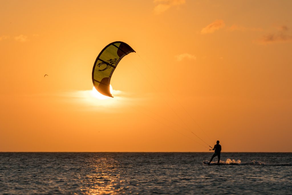 Kite surfing during sunset.